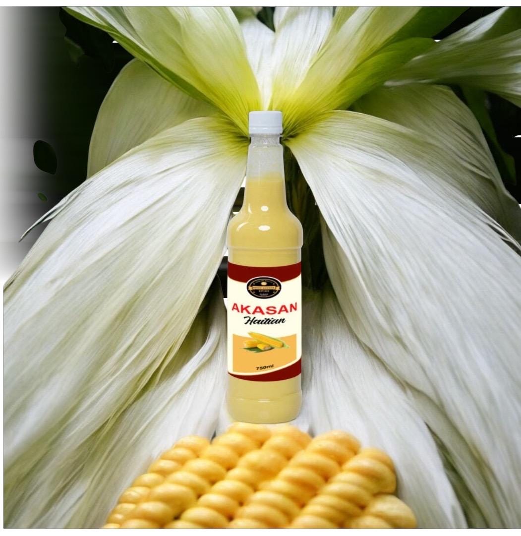 May include: A 250ml bottle of Aksan Haitian corn drink. The bottle is clear, showing a pale yellow liquid. The label is dark red and features the brand name &#39;Aksan&#39; and &#39;Haitian&#39; in white text.  A small image of corn is also on the label. The bottle is positioned in front of corn husks and ears of corn.